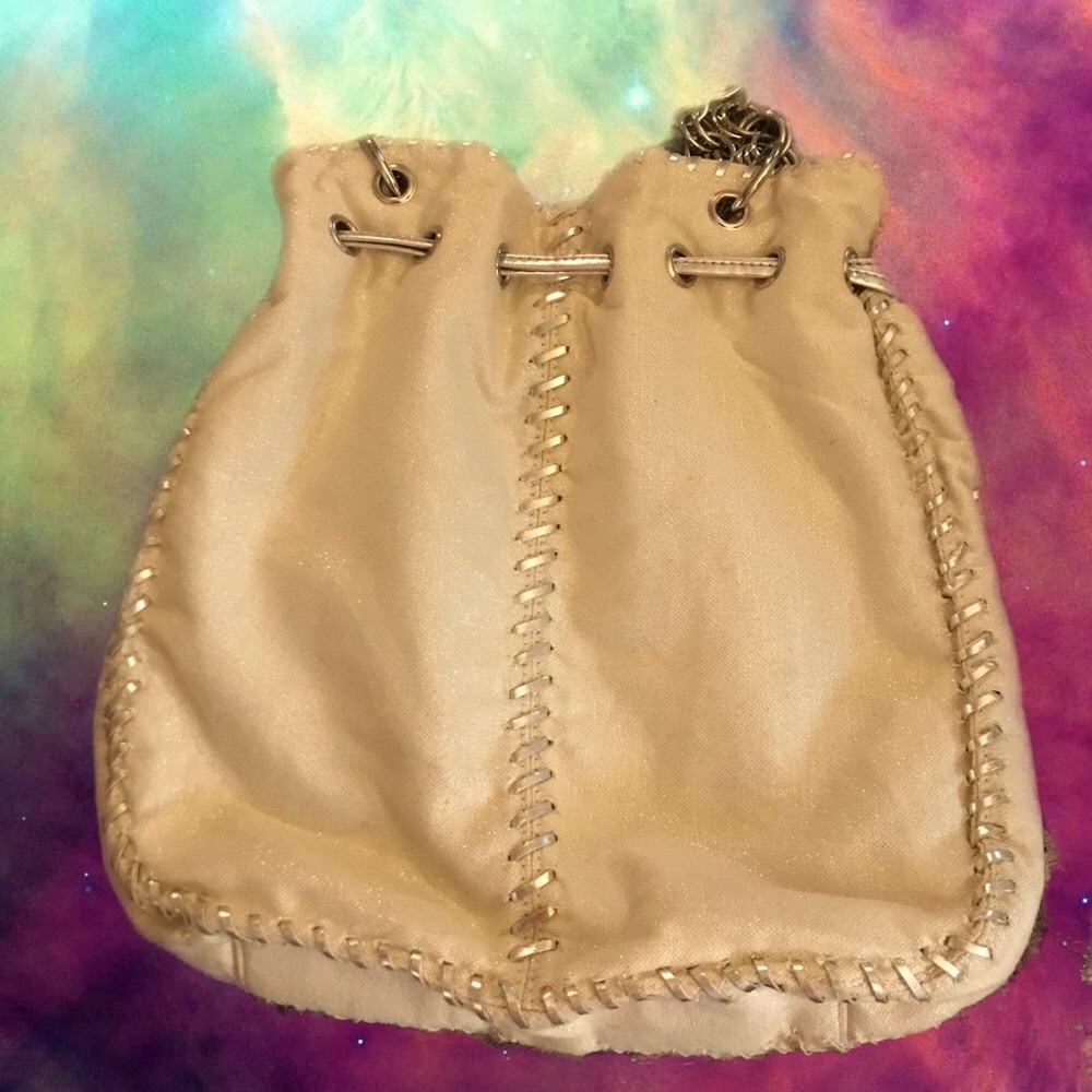 LAKE SHORE DRIVE Sack purse in beige with silver trim as part of the handles.,